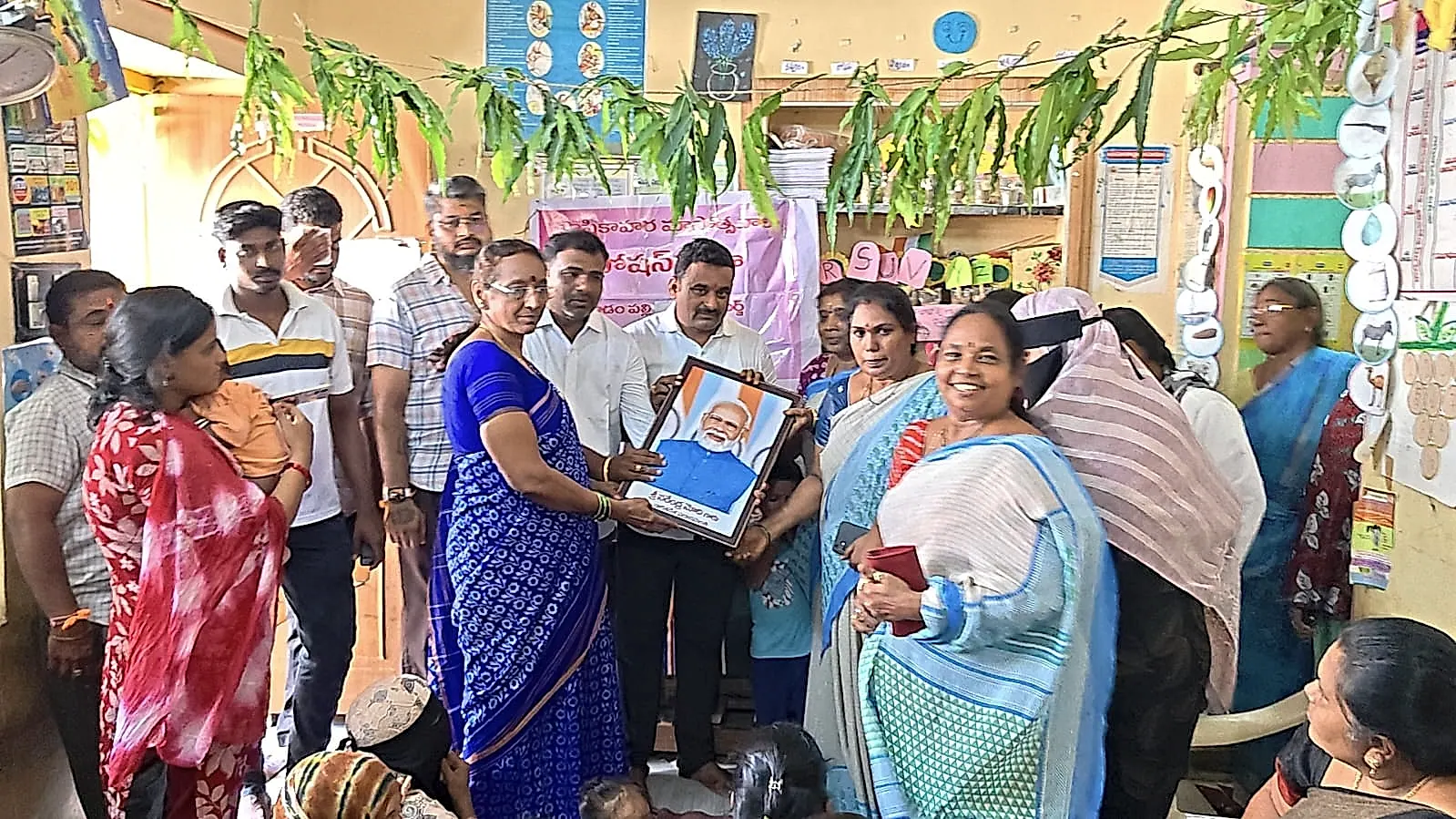 మోదీ చిత్రపటాల పంపిణీ, చిన్నారులకు స్లేట్లు అందజేత